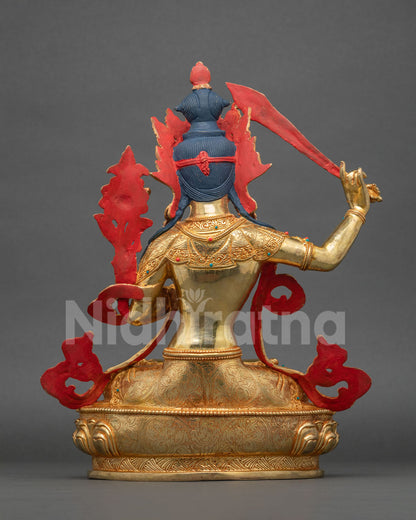 Manjushri statue floral motif silk garment and ornate jewelry back view.