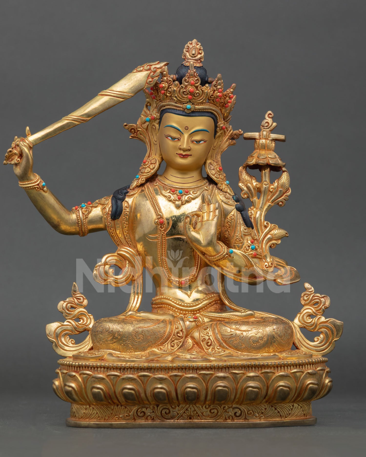 Front view of a handmade Manjushri statue with gold gilding and semi-precious stones