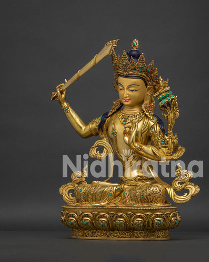 Manjushri statue gold gilded left side view with jeweled ornaments