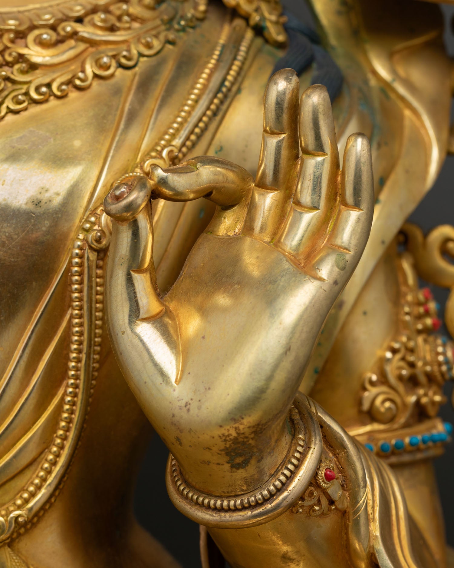 Manjushri statue hand mudra close-up, gold gilded copper craftsmanship