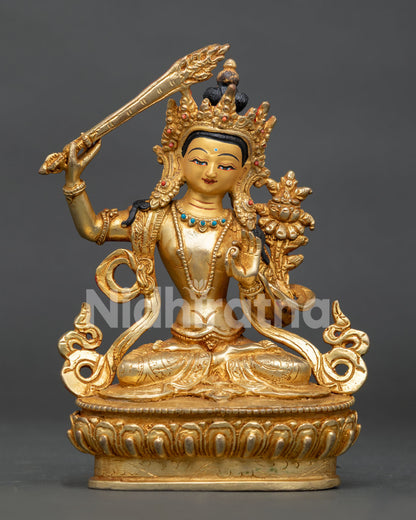 Manjushri statue holding flaming sword and prajnaparamita scripture on lotus throne.