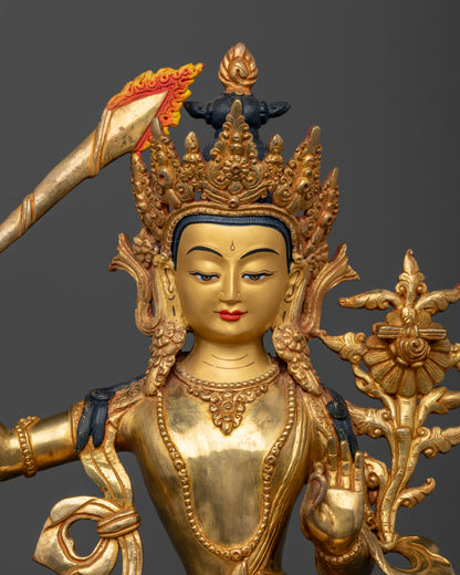 Manjushri Statue in copper with gold fire gilded finish and 24K gold painted face.