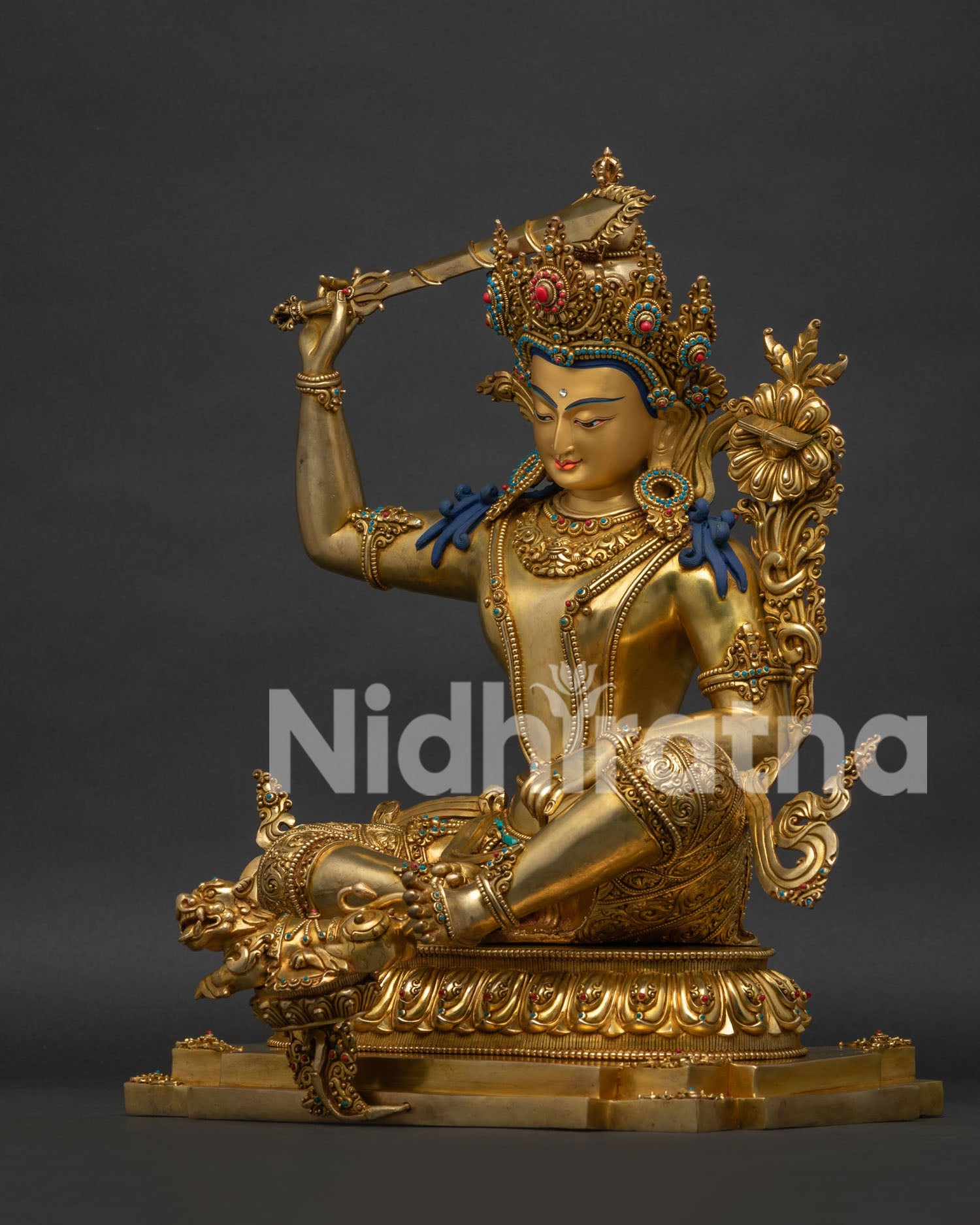 Manjushri statue left profile, gold-gilded copper with intricate hand tooling