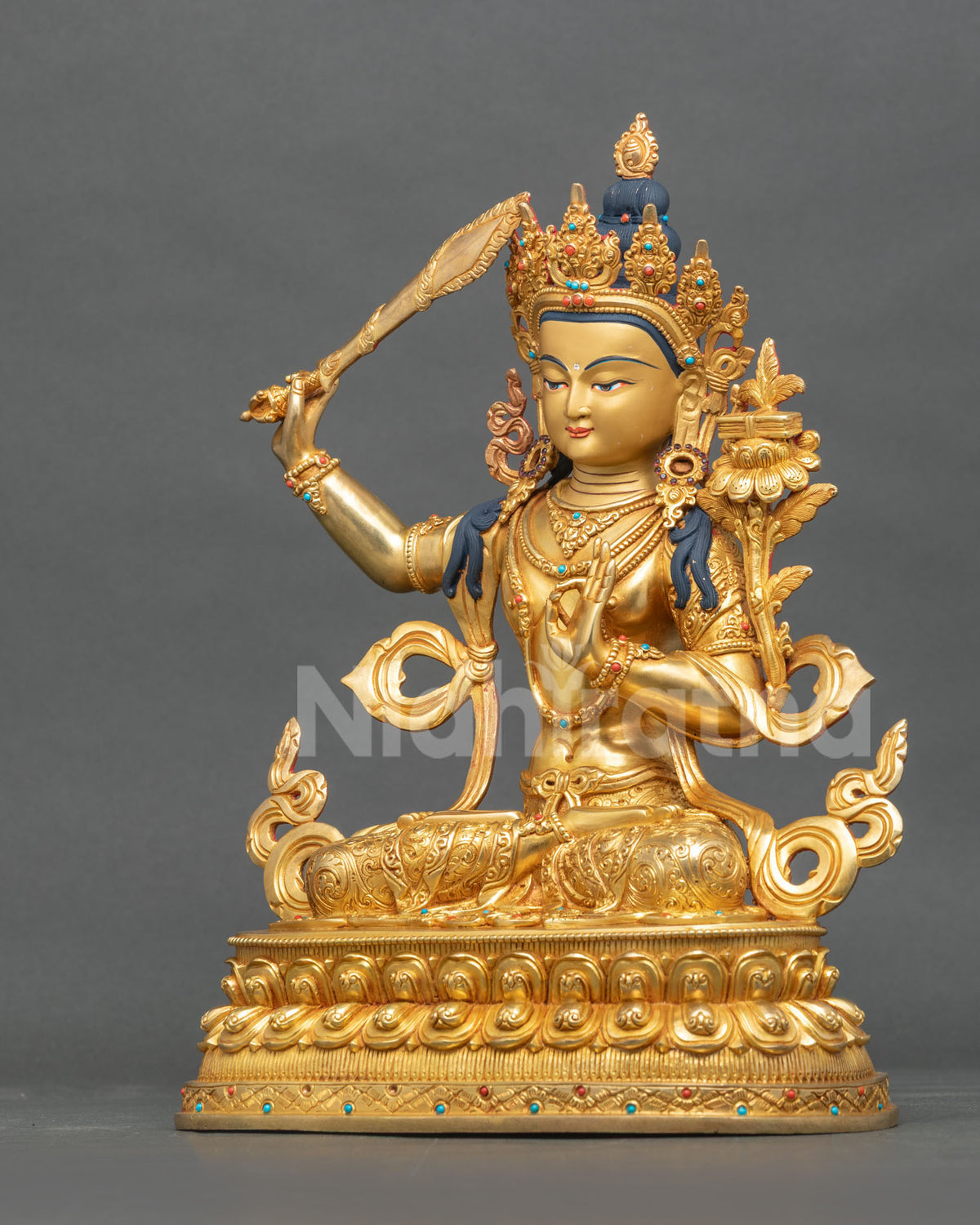Manjushri Statue left view five jewel crown semi precious stones.