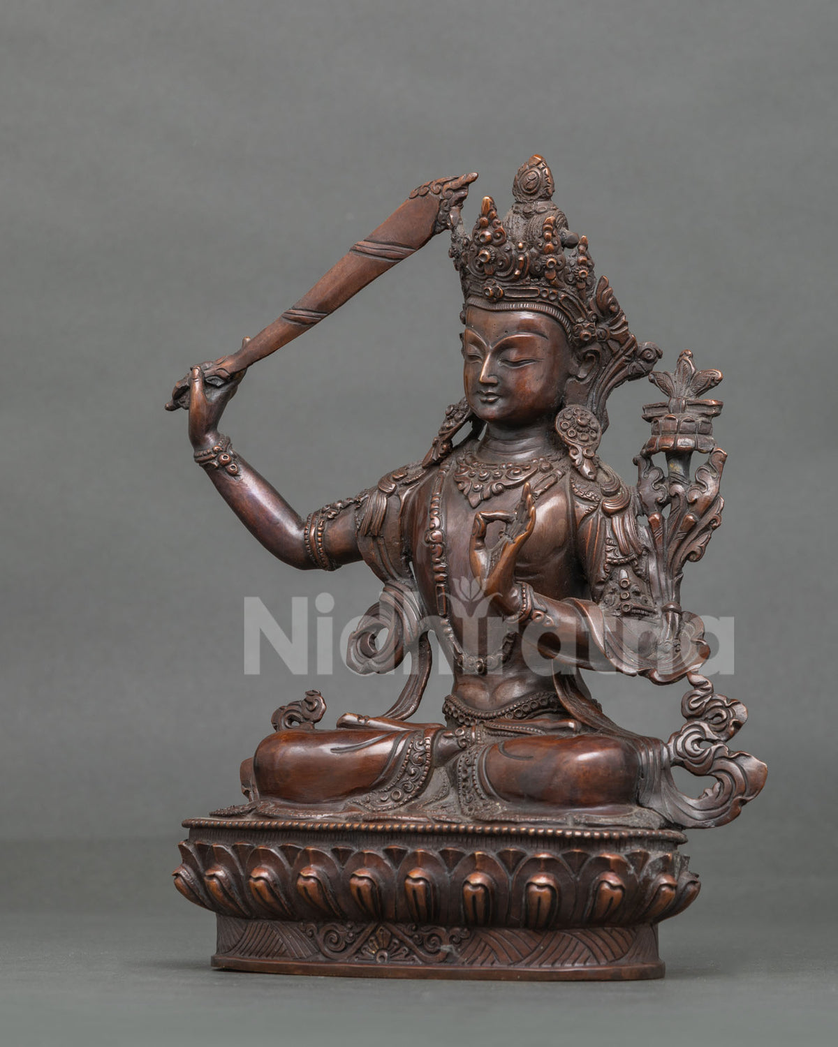 Manjushri Statue left view Prajnaparamita Sutra lotus flower Buddhist sculpture.