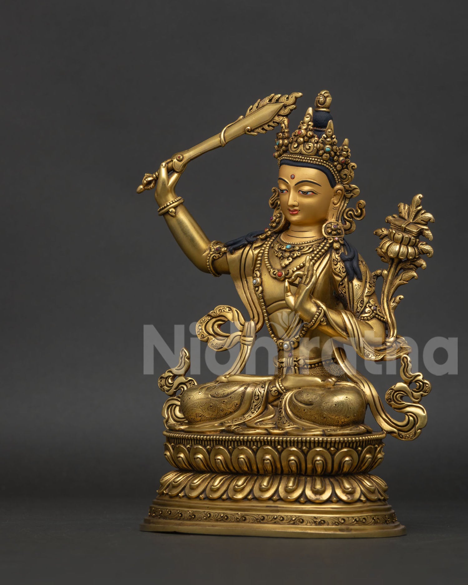 Manjushri statue left view side showing lotus flower, Prajnaparamita Sutra and jewelry