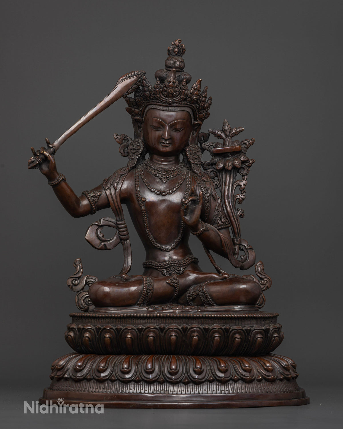 Manjushri statue made from oxidized copper using traditional lost-wax casting by a Newari artisan in Patan, Nepal.