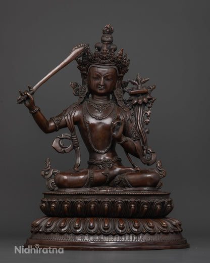 Manjushri statue made from oxidized copper using traditional lost-wax casting by a Newari artisan in Patan, Nepal.