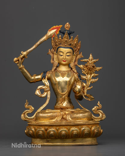 Manjushri Statue raising sword of wisdom and holding Prajnaparamita Sutra.