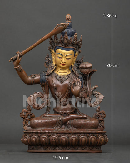 Manjushri statue seated on hand carved lotus pedestal with 24k gold painted face.