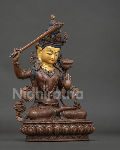 Manjushri statue with flaming sword of wisdom and prajnaparamita sutra on lotus.