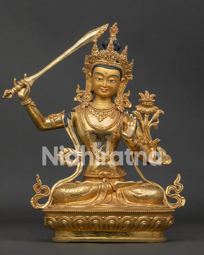 Manjushri statue with gold fire gilded copper finish seated on lotus pedestal from Nepal.