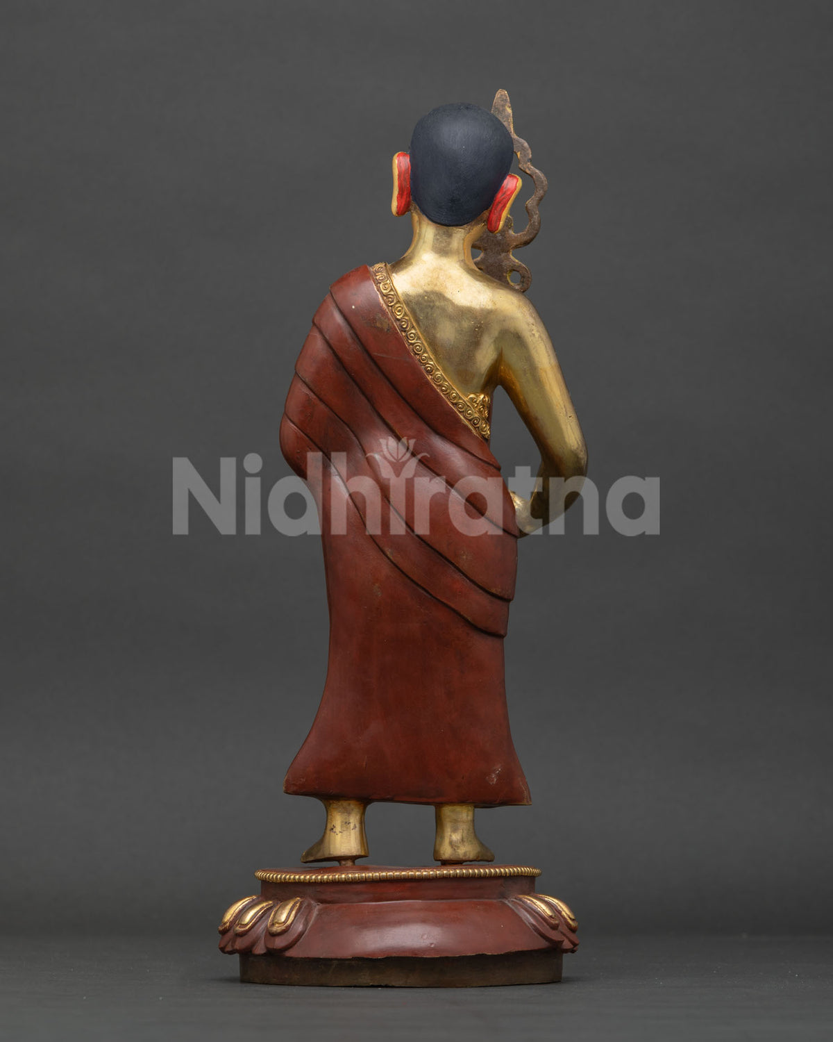 Maudgalyayana statue back view, engraved robe and lotus pedestal detail