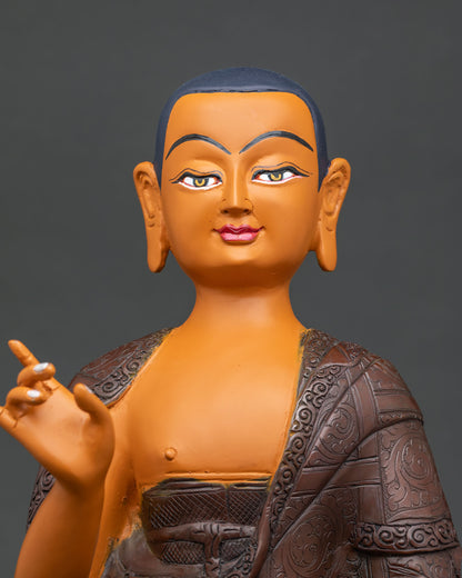 Maudgalyayana statue close up, engraved copper monastic robe detail
