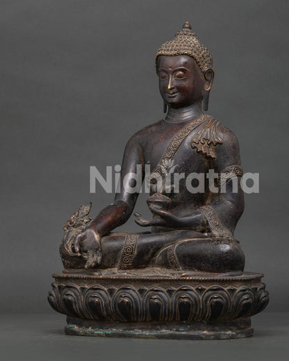 Medicine Buddha Bhaisajyaguru statue holding sacred medicine bowl.