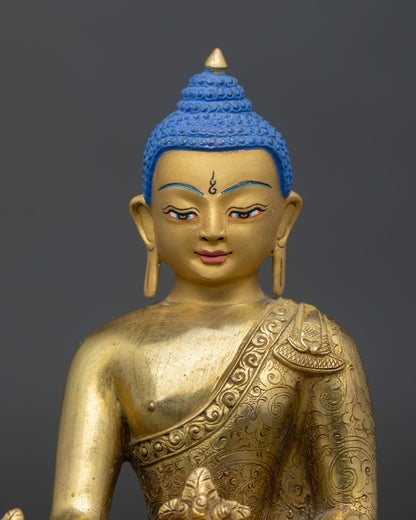Medicine buddha face with gold painted details and serene expression.
