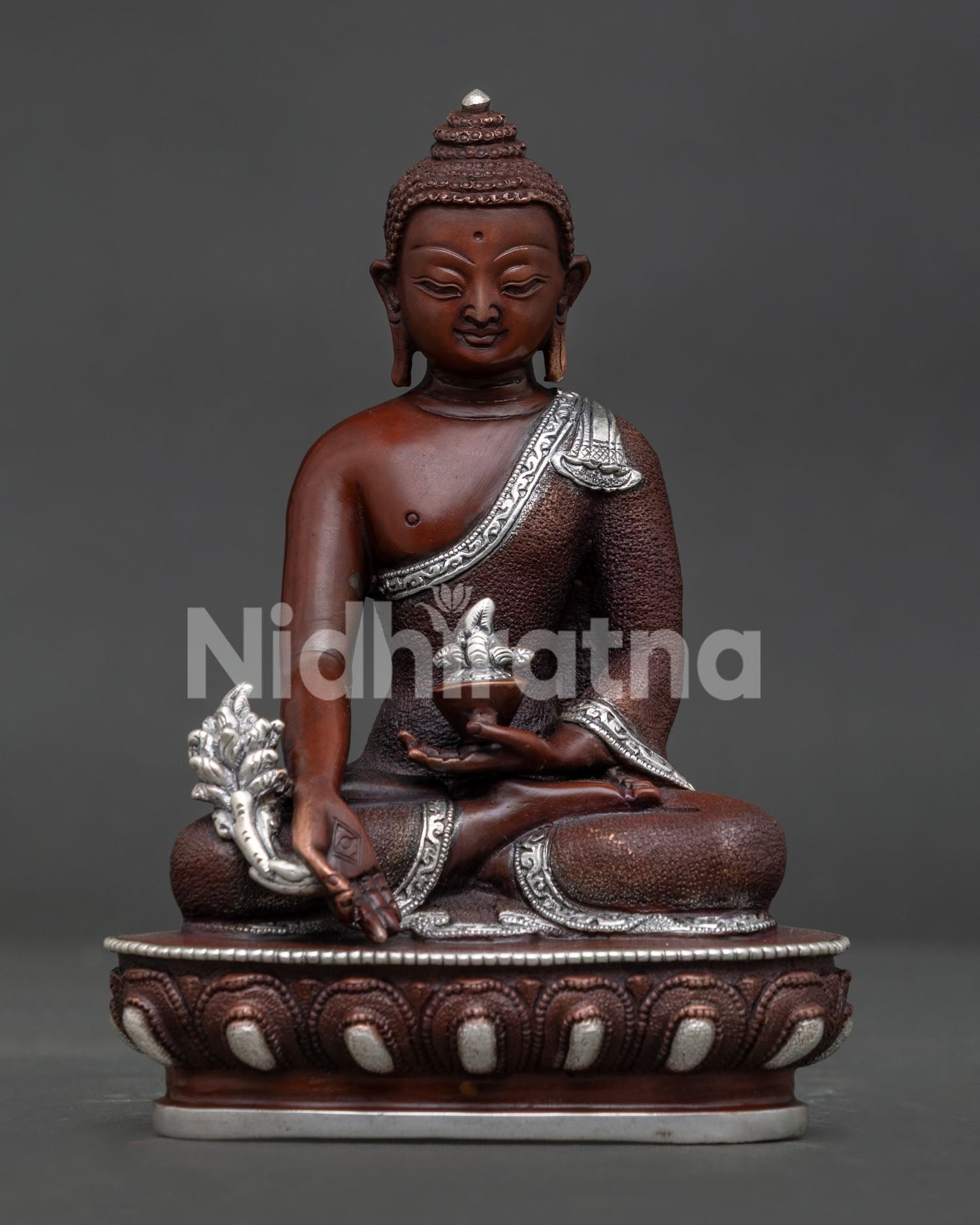 Medicine Buddha oxidized copper statue with silver plated details front view.