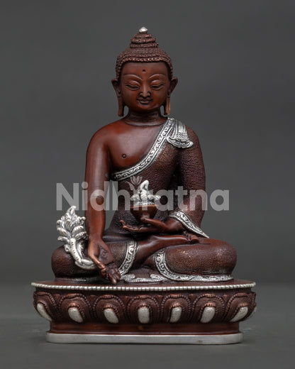 Medicine Buddha oxidized copper statue with silver plated details front view.