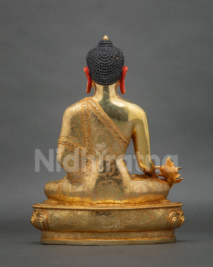 Medicine Buddha seated on a hand-carved lotus pedestal.