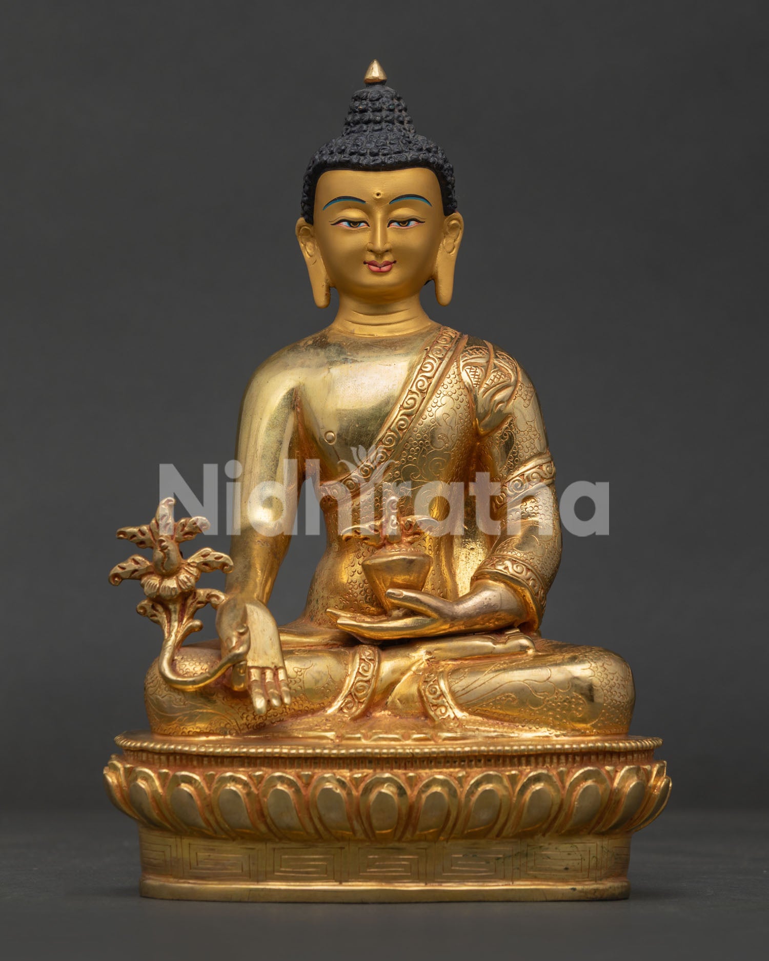 Medicine Buddha seated on lotus pedestal holding healing bowl and Myrobalan plant.
