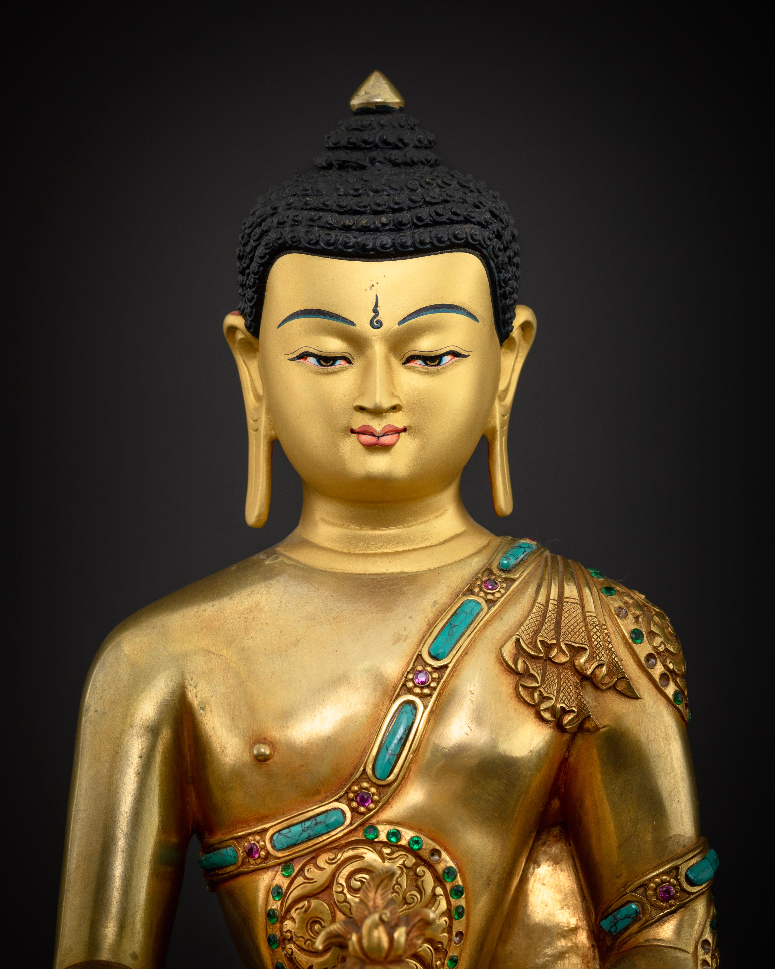 Medicine Buddha statue close-up, gold gilded copper with turquoise stone inlay detail