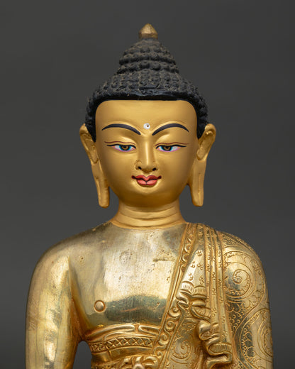 medicine buddha statue close up showing copper body and gold painted details