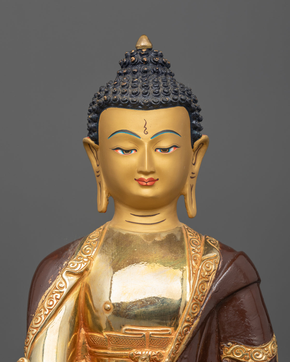 Medicine Buddha statue made from copper with a half oxidized and gold fire gilded finish and 24K gold painted face.