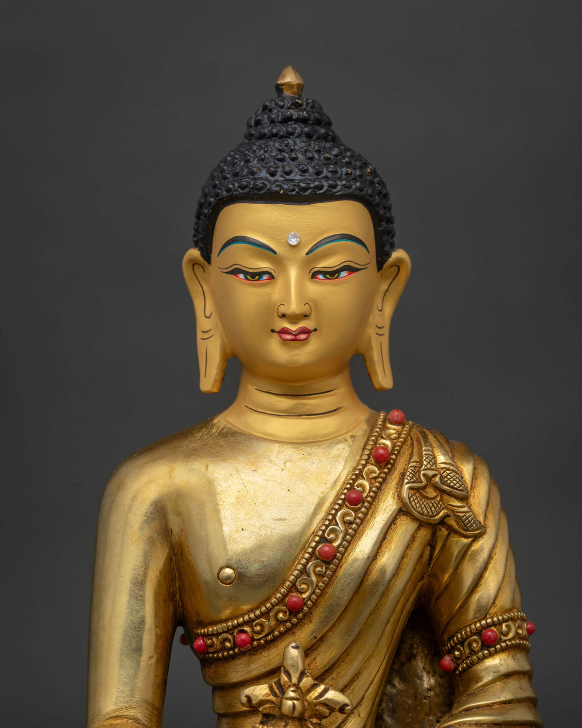 Medicine buddha statue from patan nepal with gold fire gilding and 24k gold painted face.