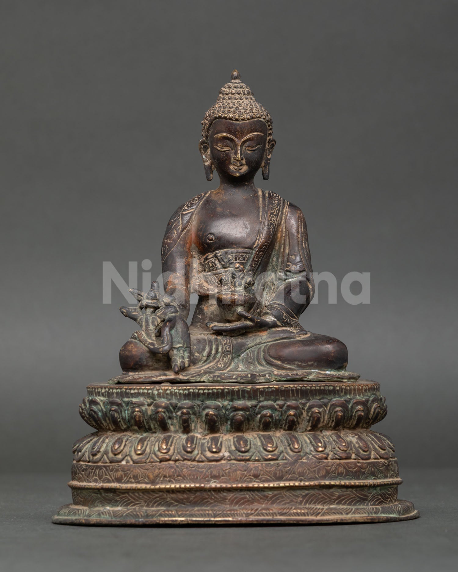 Medicine Buddha statue handcrafted in Nepal with oxidized copper on double lotus pedestal.