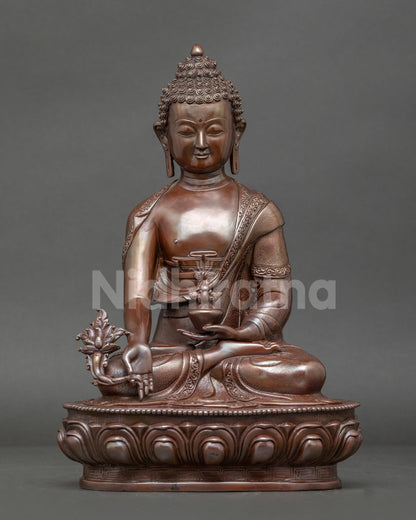 Medicine Buddha statue handcrafted in Patan Nepal. Oxidized copper seated on lotus throne with healing nectar bowl