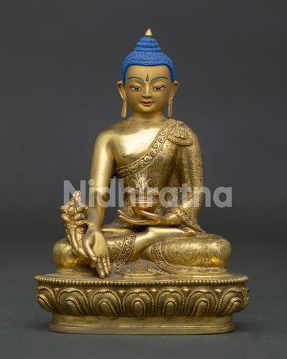 Medicine buddha statue holding healing bowl and myrobalan plant on lotus throne.
