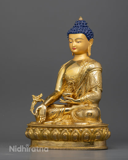 Medicine Buddha statue holding sacred medicinal bowl in left hand.