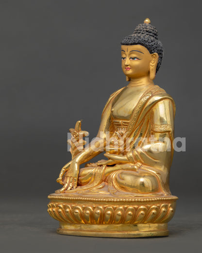 Medicine buddha statue seated on lotus throne holding healing bowl and myrobalan plant.