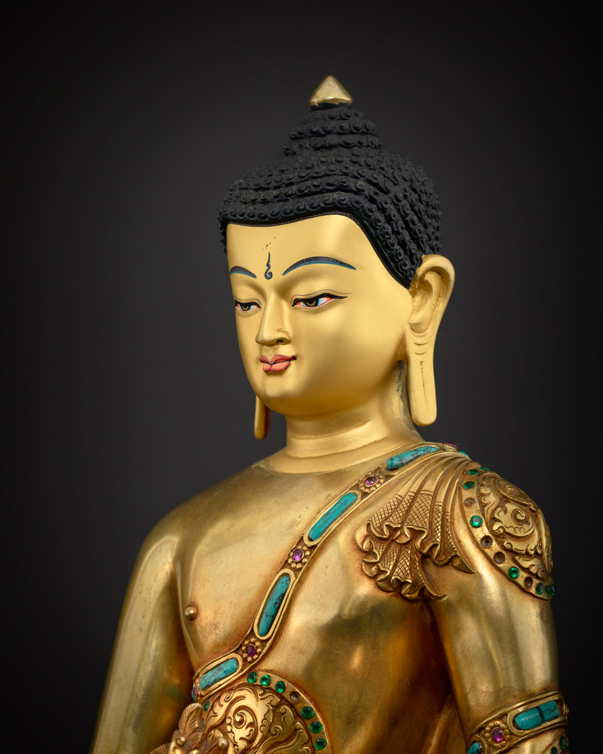 Medicine Buddha statue side close-up, turquoise inlaid robe and 24K gold gilding detail