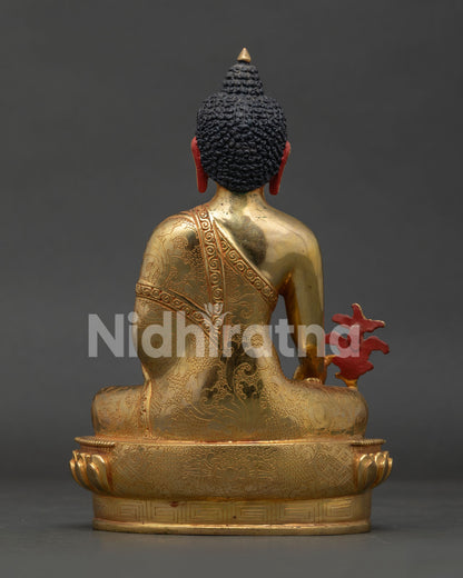 Medicine Buddha statue with carved vajra lotus pedestal and gilded finish.
