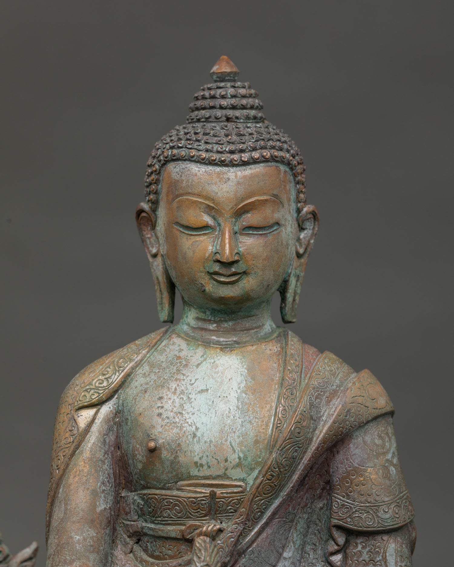 Medicine Buddha statue with oxidized antique copper finish.