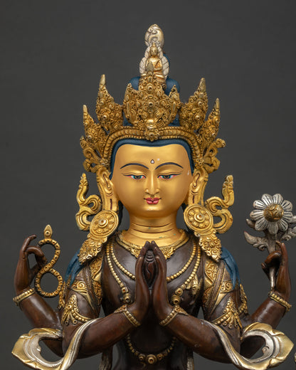 Mid-shot close-up of 4-armed Chenrezig statue holding crystal mala and lotus flower on oxidized copper finish.