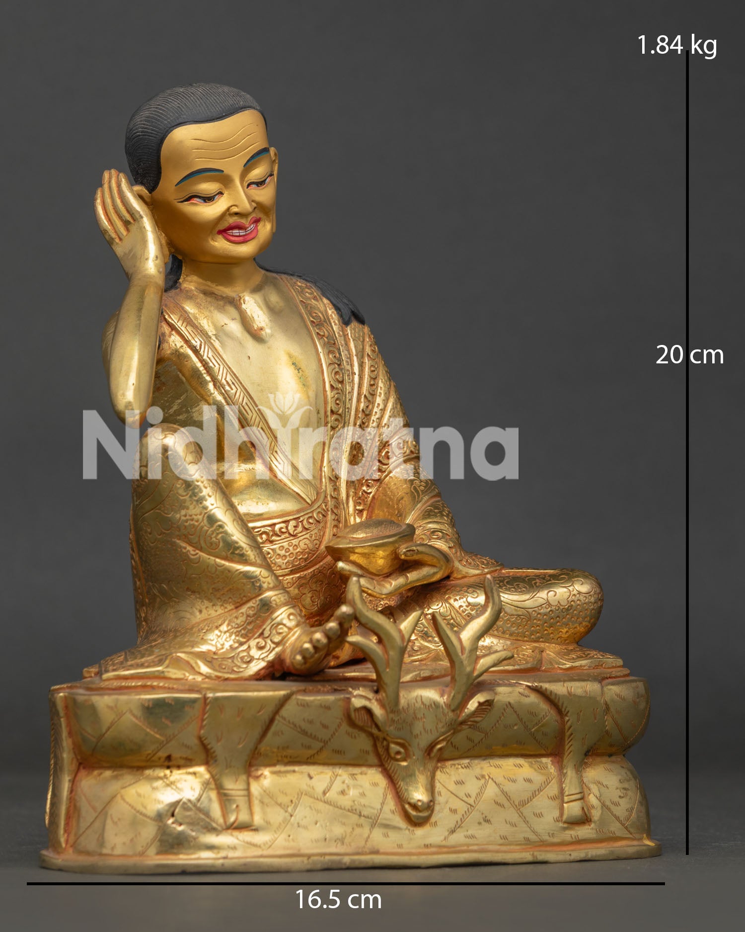 Milarepa statue in listening gesture holding kapala with traditional Tibetan yogi posture.