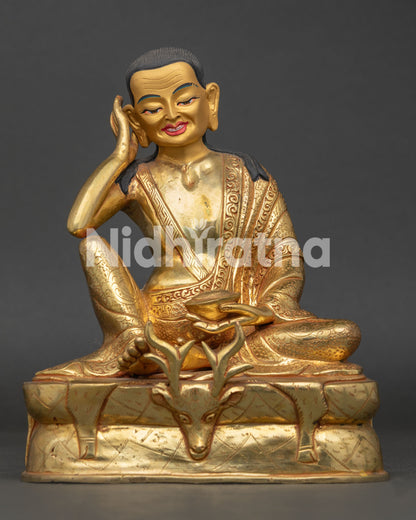 Milarepa statue with gold fire gilded copper finish seated on engraved deer skin pedestal from Nepal.