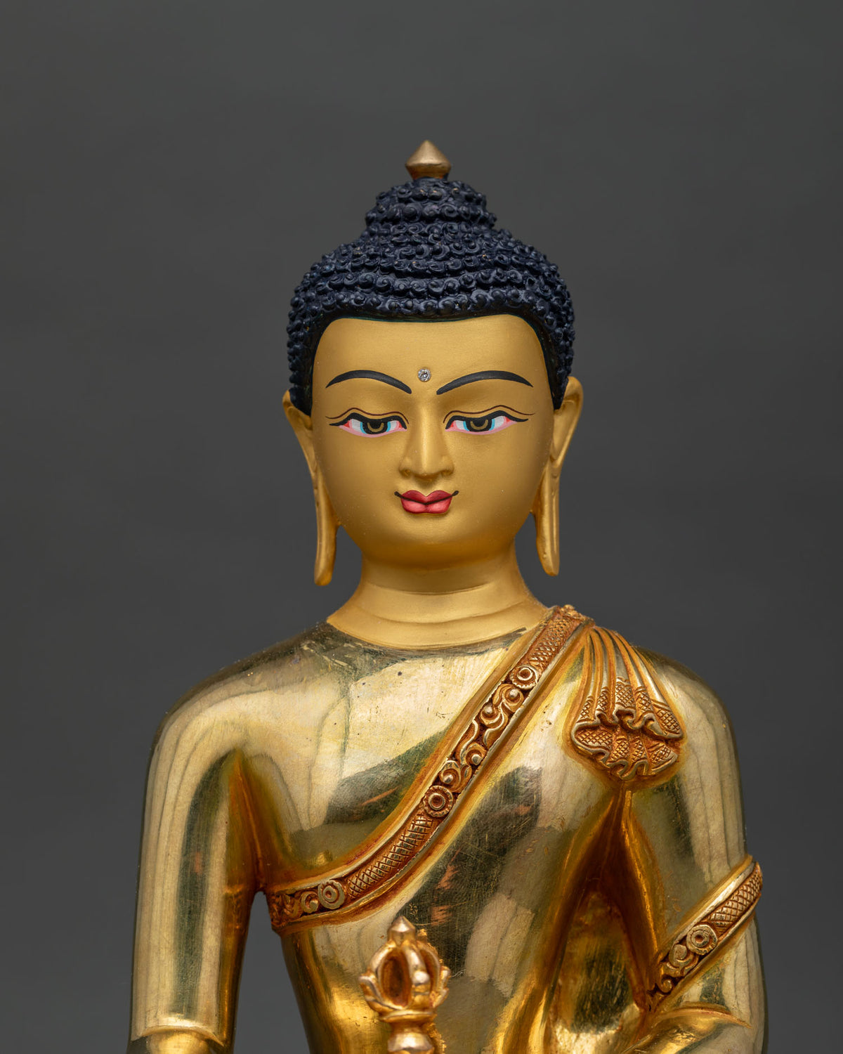 Mitrugpa statue with intricate traditional details and serene expression.