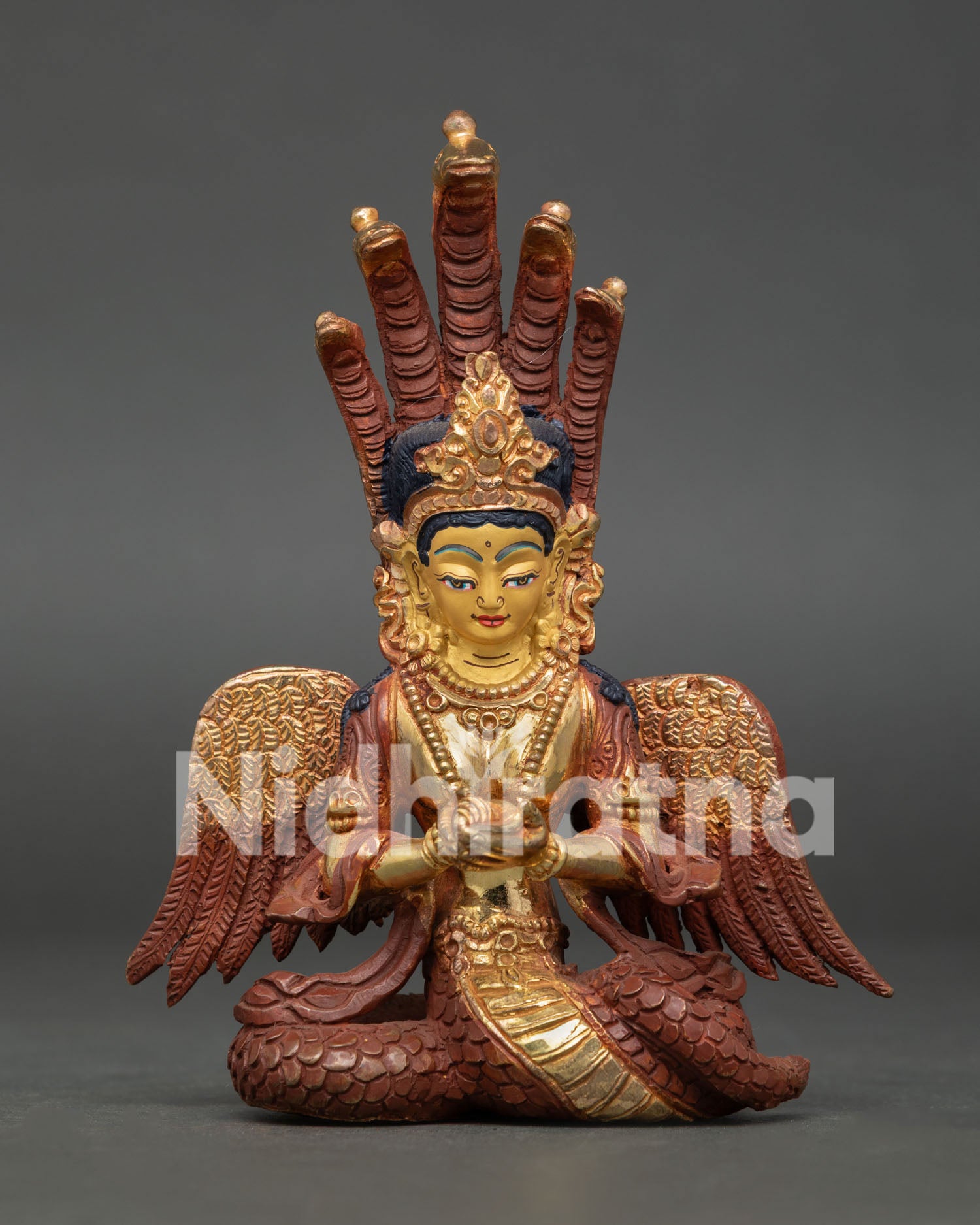 Naga Kanya statue handcrafted in Nepal with gold-painted face and fire-gilded copper body.