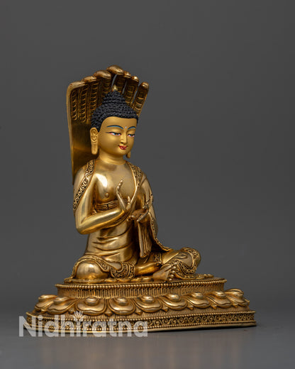Nagarjuna Buddhist sculpture with a seven cobra Naga halo and intricate gold gilded ornaments.