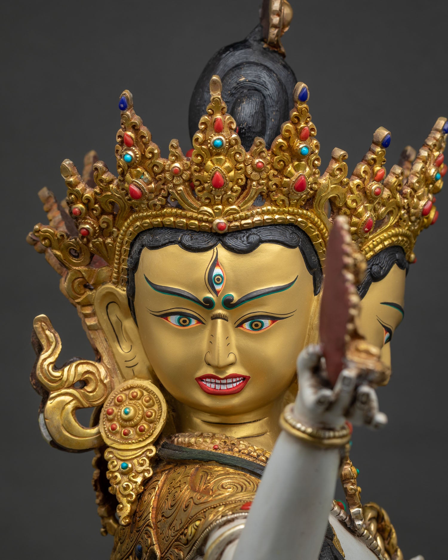 namgyalma face side close up crown detail gold gilding tranquil expression