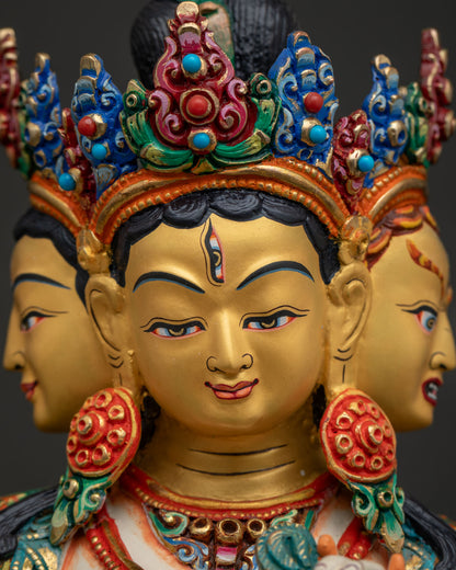 Namgyalma statue face close-up, three gold-painted faces of Buddhist goddess