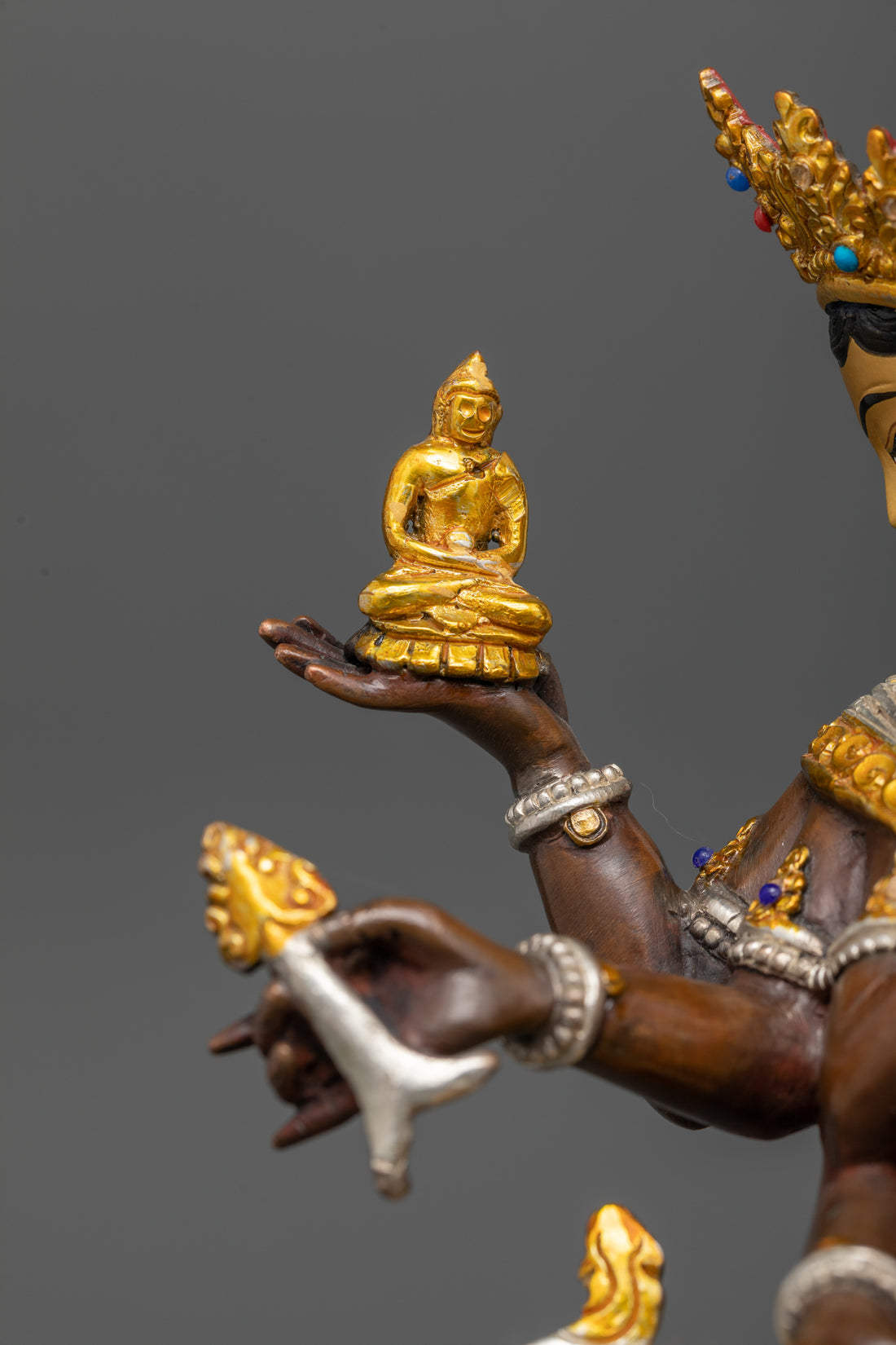 one of the hands of namgyalma statue holding amitabha buddha 