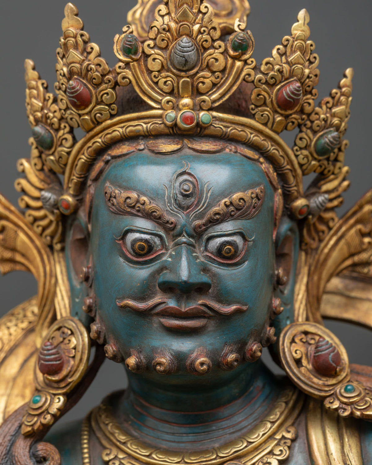 Namtoshe Statue face close up with third eye, fierce expression and jeweled crown