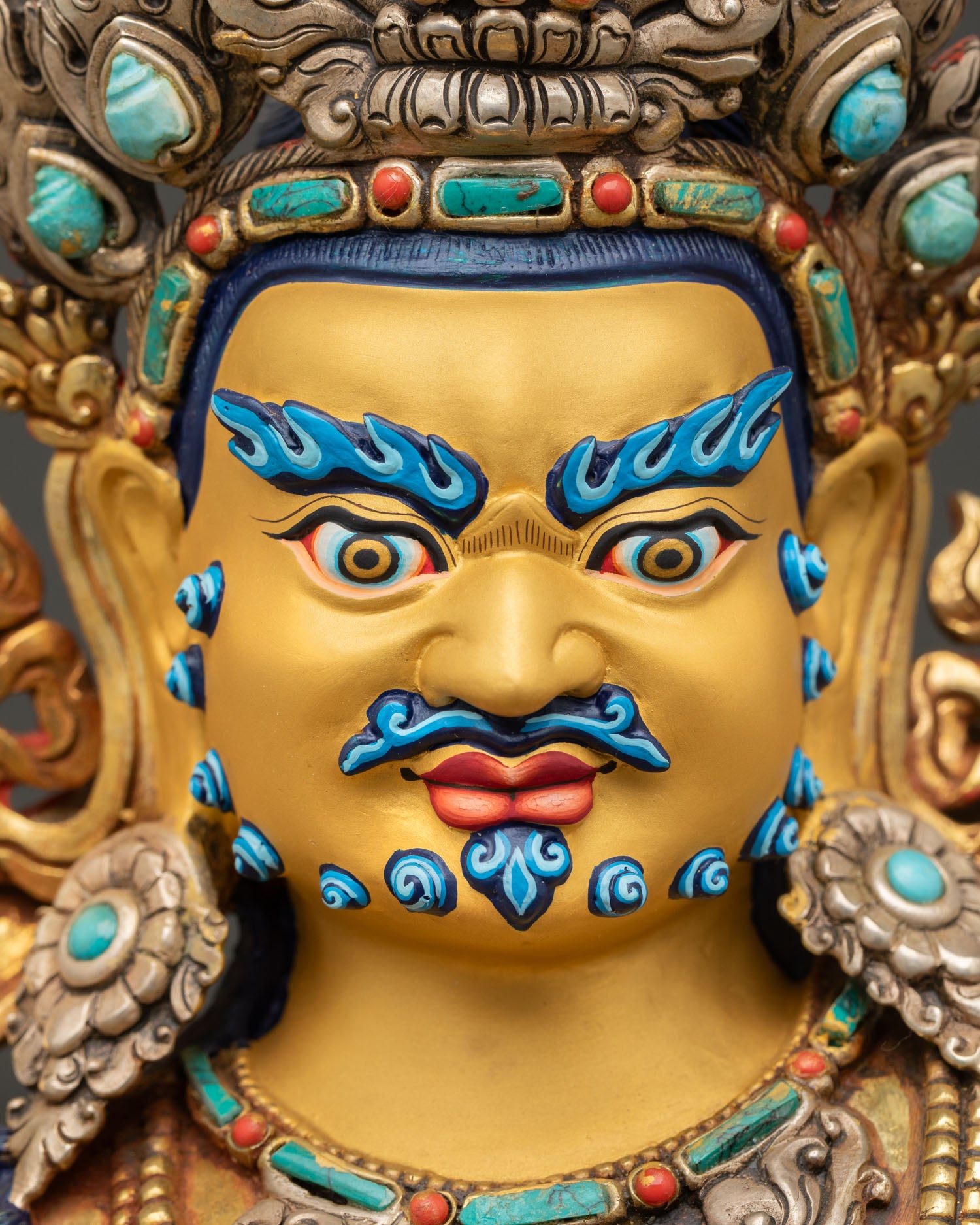 Namtoshe Wealth Deity face close-up showing blue face and sacred ornaments