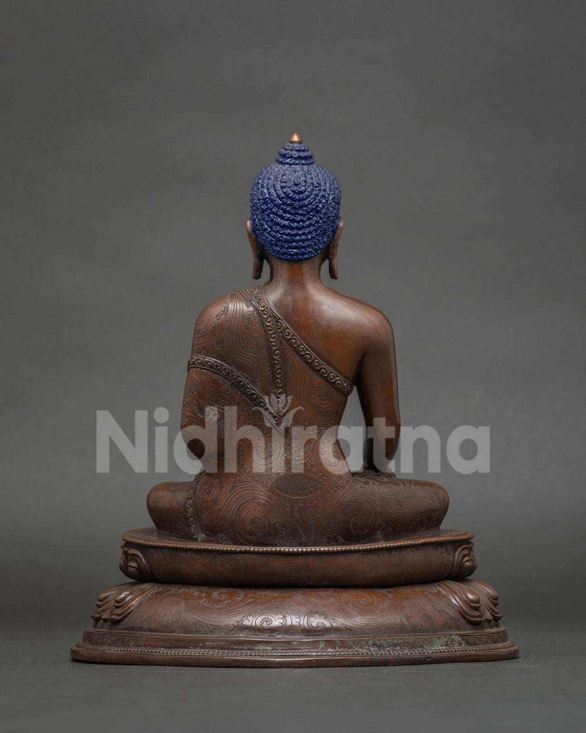 Nepalese Buddha statue displayed on a home altar for meditation.
