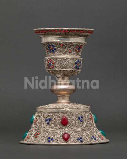Nepalese Buddhist butter lamp featuring turquoise coral and lapis lazuli gemstone detailing.