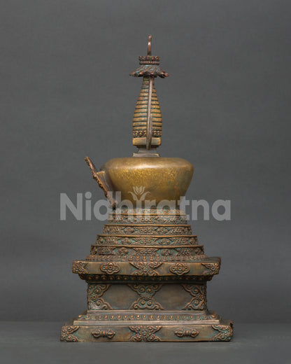 Nepalese buddhist stupa with intricate floral engraving and carved base.